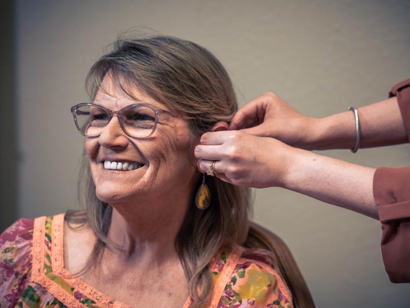 woman getting fitted for hearing aids