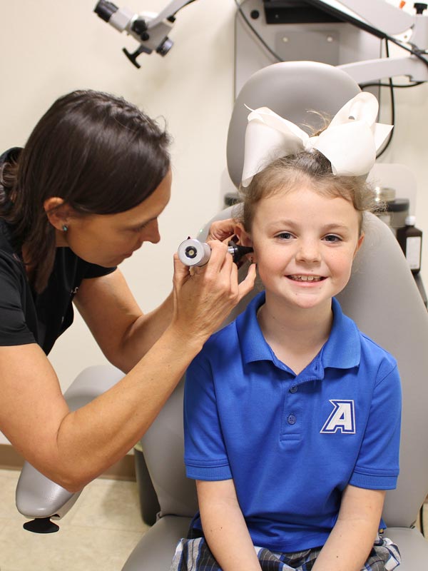 Amanda Duke looking into kid's ear