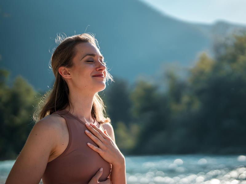 woman breathing easy outside