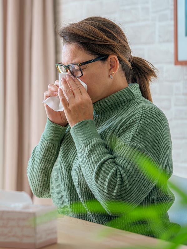 woman blowing her nose
